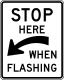 Stop here when flashing &mdash; Regulatory sign &mdash; Parking and Emergency Restrictions (MUTCD R8-10A)