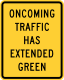 Oncoming traffic has extended green &mdash; Regulatory sign &mdash; Oncoming Traffic Has Extended Green Signs (MUTCD W25-1)