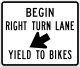 Begin right turn lane yield to bikes &mdash; Regulatory sign &mdash; Regulation of Movement Signs (MUTCD R4-4)